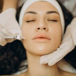 woman making injections cosmetologist